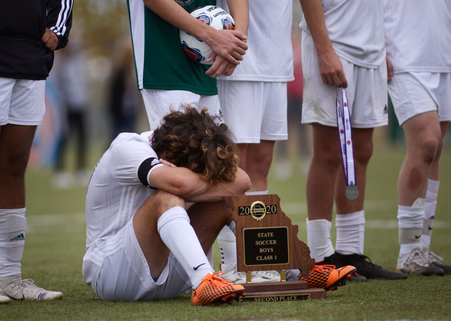 Whitfield midfielder Francisco Gervasoni buries his head in his arms